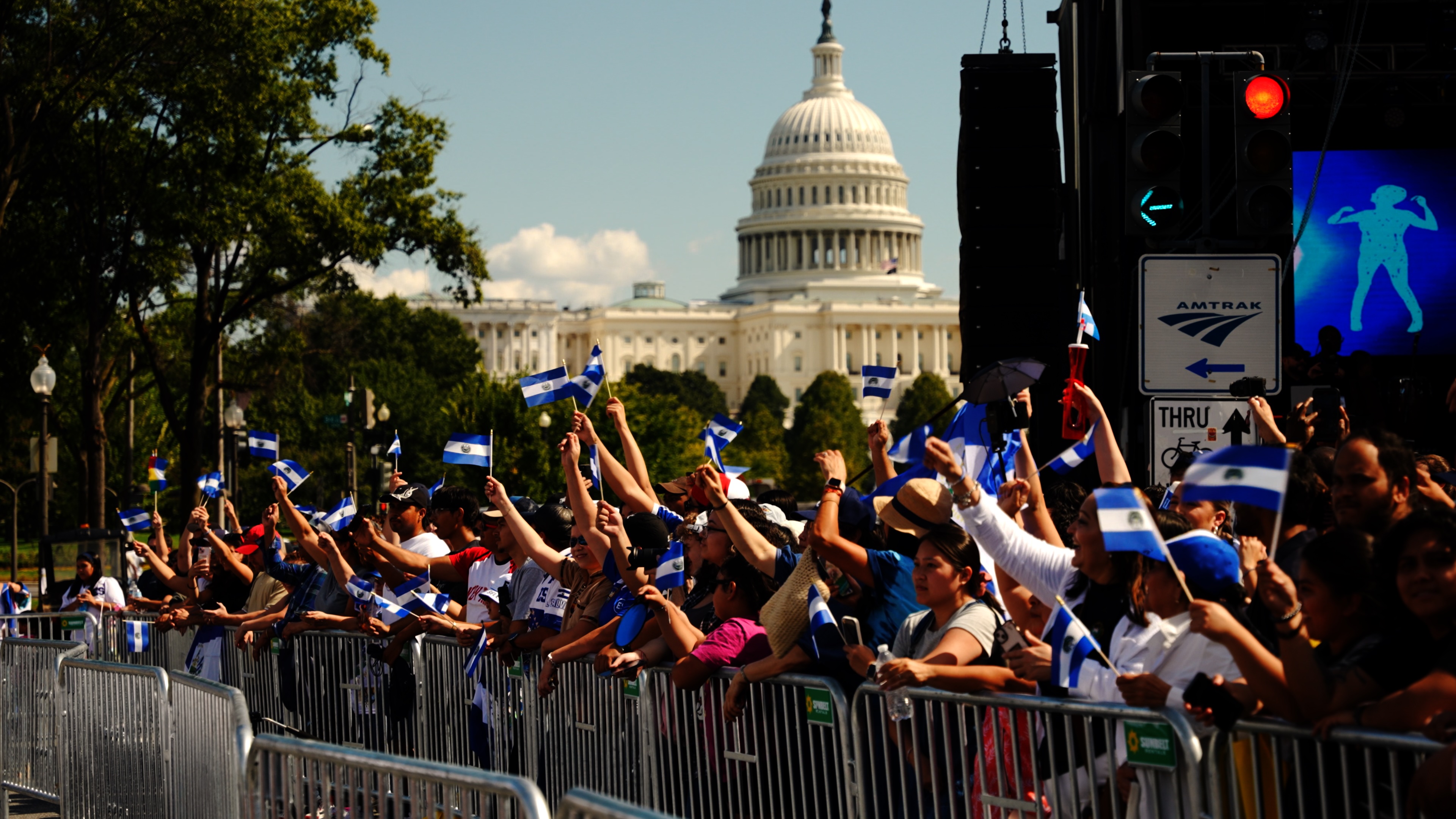 Crowd waving Salvadoran flags near the U.S. Capitol during Fiesta DC